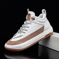 Macro detail view of premium white leather high-top sneakers with brown suede accents - 39 / White