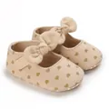 Detail view of soft cotton baby walking shoes with heart pattern and large decorative bow. - Heart Printed
