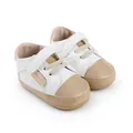 Detailed view of white and tan baby walking shoes featuring a Velcro strap and side label - Apricot