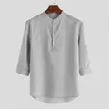 Primo piano di una camicia grigia con colletto alla coreana, maniche a tre quarti e bottoni - Taglia S / Top / Grigio