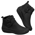 Detailed side view of classic black leather ankle boots featuring decorative buckles. - 35 / Black