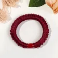 Primer plano de un coletero de seda plisada burdeos con cuenta decorativa roja - Estilo Delgado / Burdeos
