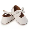 Detail view of white soft-sole baby walking shoes with elegant bow and scallop trim - White