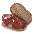 Detail shot of reddish-brown soft sole baby sandals with anti-slip rubber texture - Brown