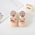 Detailed view of cream-colored baby sock shoes with pink cartoon bear and Honey text - Beige (Bear Letter)