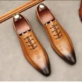 Classic men's brown leather Oxford shoes with brogue carving details on grey background - 36 / Yellow Brown