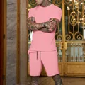 Detail view of a men's solid pink short-sleeved T-shirt and sports shorts set on a model - M / Top And Bottom / Pink