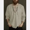 Close-up of men's casual V-neck linen shirt with embroidered drawstring neck detail - Grey Brown