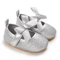 Detailed view of silver glitter baby Mary Jane shoes featuring a grey satin bow - Silver