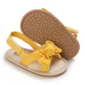 Detail of yellow baby girls sandals with eyelet fabric bow and soft non-slip sole. - Yellow