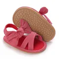 Macro detail of red baby girl sandals with soft non-slip sole and bow - Rose Red
