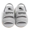 Detailed top view of grey mesh baby sandals with embroidered gothic text on straps - Light Gray