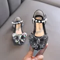 Elegant black girls princess shoes featuring a large rhinestone butterfly and pearl strap - Black