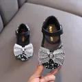 Sparkling black rhinestone girls' Mary Jane shoes with large silver crystal bow detail. - 21 / Black