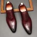 Macro detail of burgundy leather brogue dress shoes featuring intricate toe carvings. - 37 / Burgundy