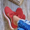 Detail of red suede platform Mary Jane shoes featuring a decorative bow and thick white soles - 35 / Red