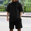 Detailed view of men's black oversized summer tracksuit set in breathable fabric - M / Top And Bottom / Black