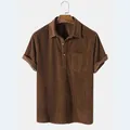 Close-up detail of a brown corduroy short sleeve shirt with chest pocket and collar - Brown