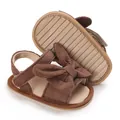 Close-up of brown corduroy baby sandals with bow decoration and anti-slip sole - Brown