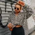 Woman wearing a leopard print fluffy fleece hoodie in an urban street fashion setting - Gray