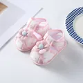 Close-up detail of pink floral baby girl walking sandals with soft fabric flower decor - Pink