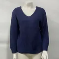 Detailed close-up of a blue V-neck knitted sweater with a textured waffle pattern - S / Tops / Blue