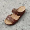 Detail of brown women's wedge sandal with elegant embroidery and white stitching - Dark Brown
