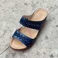 Detailed close-up of blue wedge sandals with geometric embroidered cutout straps - Blue