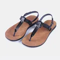 Detailed shot of women's black PU leather T-strap sandals with brown sole and buckle - 38 / Brown-Black