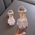 Elegant pink girls princess shoes featuring a rhinestone butterfly and pearl ankle strap - Pink