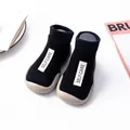 Comfortable black knit baby sock shoes featuring soft non-slip soles and a Self-Care label - Size 18/19 / Label Style / Black