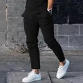 Men's high street slim fit sports casual pants shown in an outdoor street setting - M / Bottoms / Black