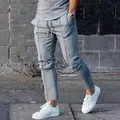 Detail view of men's slim fit grey high street joggers with drawstring waist - M / Bottoms / Light Gray