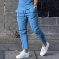 Close-up of men's slim-fit light blue casual athletic pants in a street style setting - M / Bottoms / Light Blue