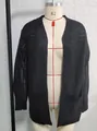 Elegant black hollow-out knit cardigan with lantern sleeves and pockets on mannequin - Black