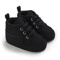 Vue détaillée de baskets en toile noire pour nourrissons avec semelles très souples - Noir