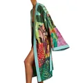 Detailed view of colorful tropical print kimono with wide sleeves and open front - M / Tops / Green