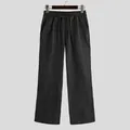 Vista frontale di pantaloni casual neri larghi da uomo su una gruccia minimalista - Taglia S / Pantaloni e gonne / Nero