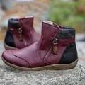 Close-up of burgundy women's short boots with side zipper and plaid detail on rocks. - 35 / Burgundy