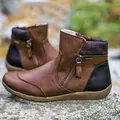 Detail shot of women's brown leather ankle boots featuring side zipper and plaid collar - 35 / Tan