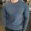 Detailed view of men's slim fit blue knitted long-sleeved sweater with vertical texture - Haze Blue