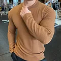 Detailed close-up of textured waffle knit fabric on a men's slim-fit long-sleeve sweater - Khaki