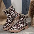 Close-up of leopard print snow boots with cozy fur lining and side zipper details. - Leopard Print