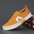 Stylish orange men's canvas sneakers with white soles and casual design for work - Turmeric