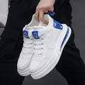Modern white leather sneakers featuring iridescent blue details and air cushion sole. - White Blue
