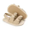 Close-up detail of beige cotton baby sandals featuring a soft anti-slip sole and cute bow - Apricot