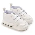 Close-up of white soft-soled baby pre-walker shoes with lace-up detail - White
