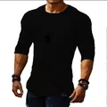 Detail of a men's slim fit round neck long sleeve T-shirt in solid black - S / Tops / Black