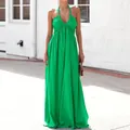 Close-up of a vibrant green deep V-neck halter maxi dress in a sunny outdoor setting. - S / Dresses / Green