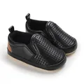 Detailed view of black PU leather baby shoes with breathable hollow-out design and soft sole - Black